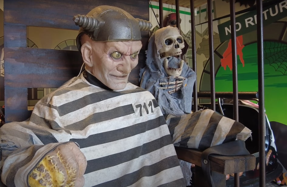 A statue of a skeleton in a jail cell.